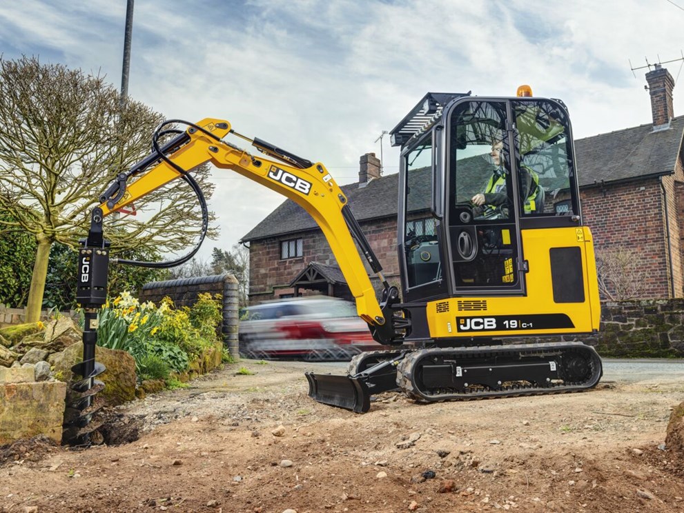 19c-1 cabbed mini excavator with drill attachment